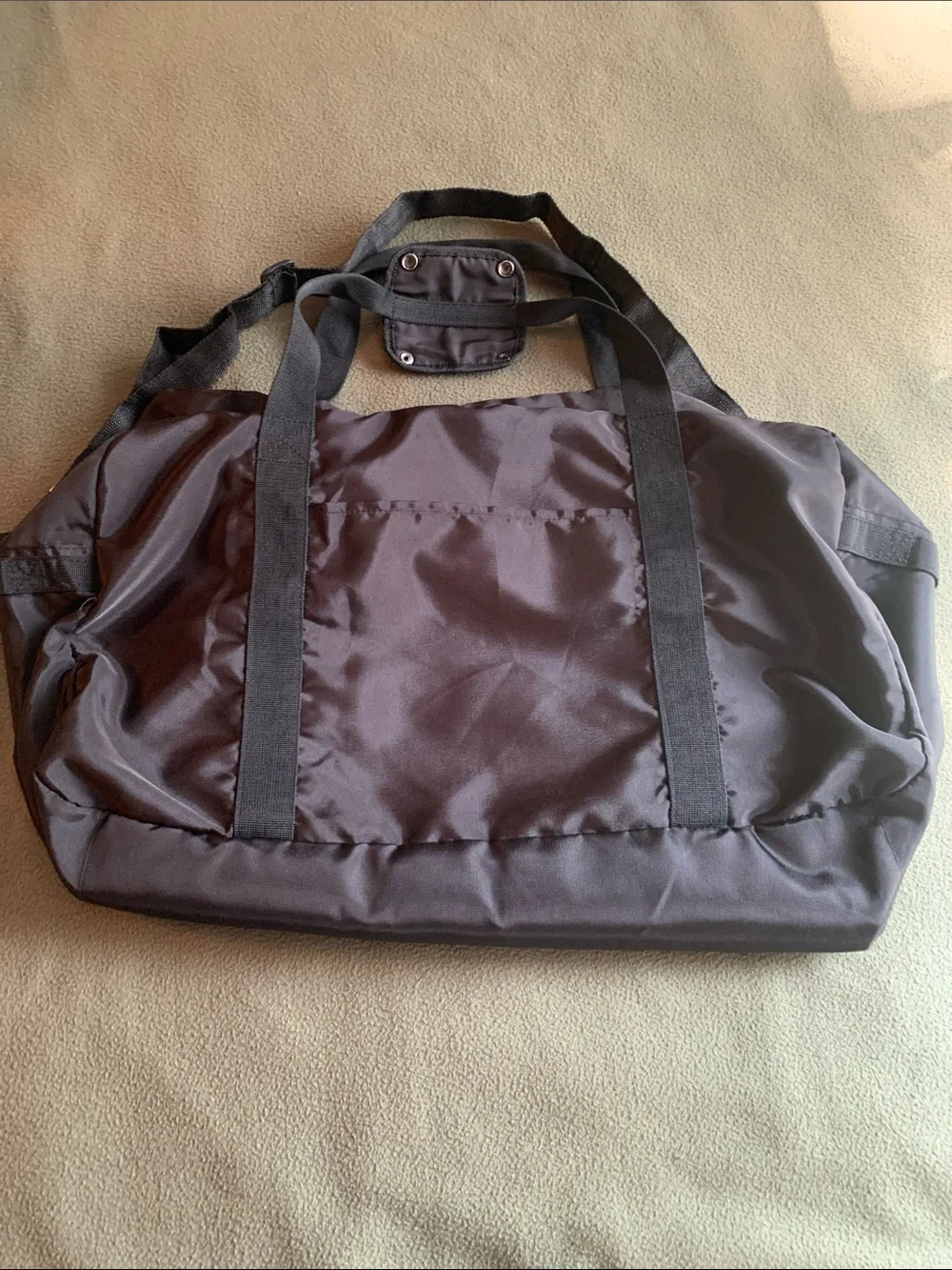 EUC black nylon duffel bag with strap. Approximately 22” x 14” x 10.5”
